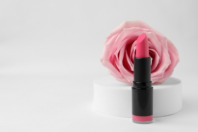 Photo of Beautiful pink lipstick and rose on white background, space for text