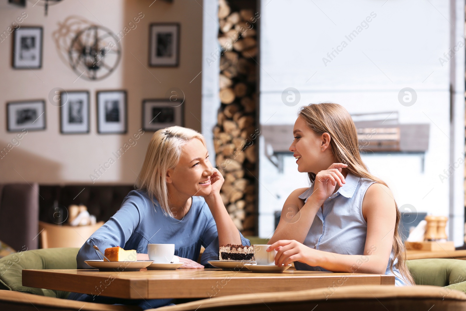 Photo of Mother and her adult daughter spending time together in cafe