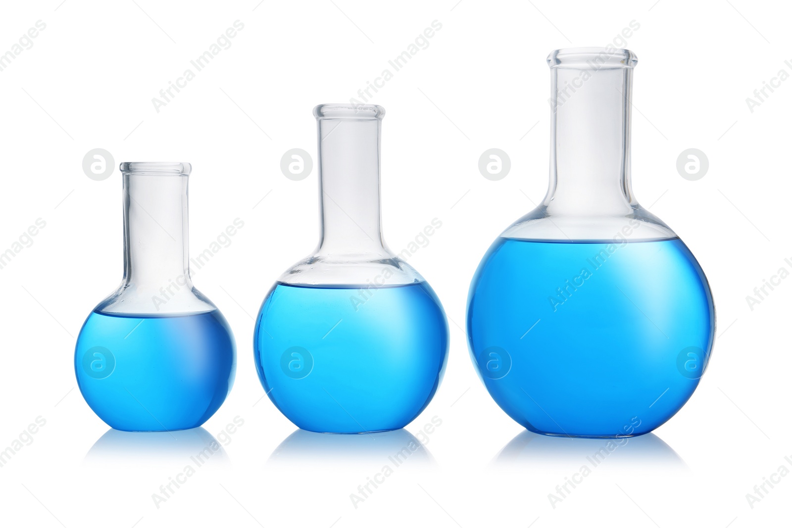 Photo of Florence flasks with blue liquid on white background. Laboratory glassware