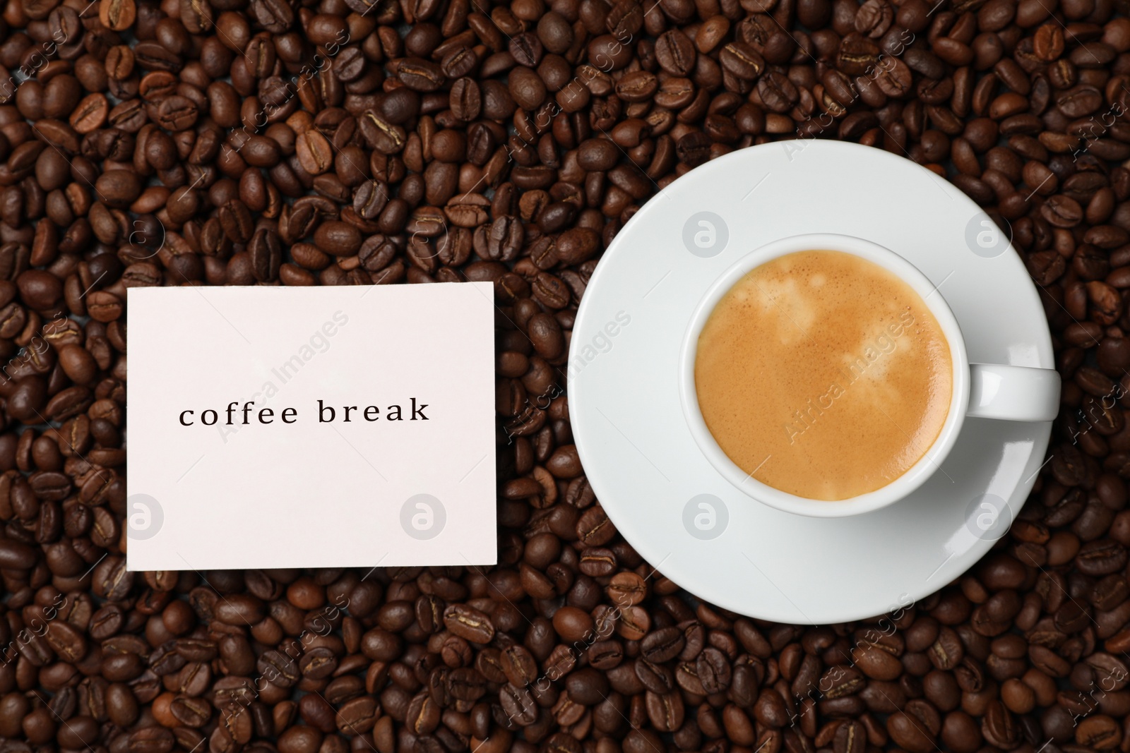 Photo of Cup of aromatic hot drink and card on beans, flat lay. Coffee break