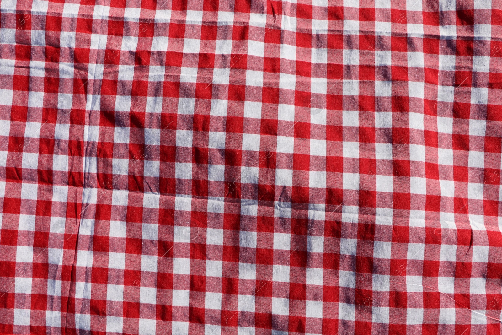 Photo of Red checkered picnic tablecloth as background, top view