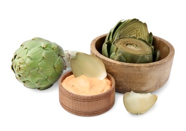 Delicious cooked artichoke with tasty sauce and fresh vegetable isolated on white