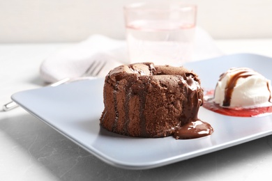 Plate of delicious fresh fondant with hot chocolate and ice cream on table. Lava cake recipe