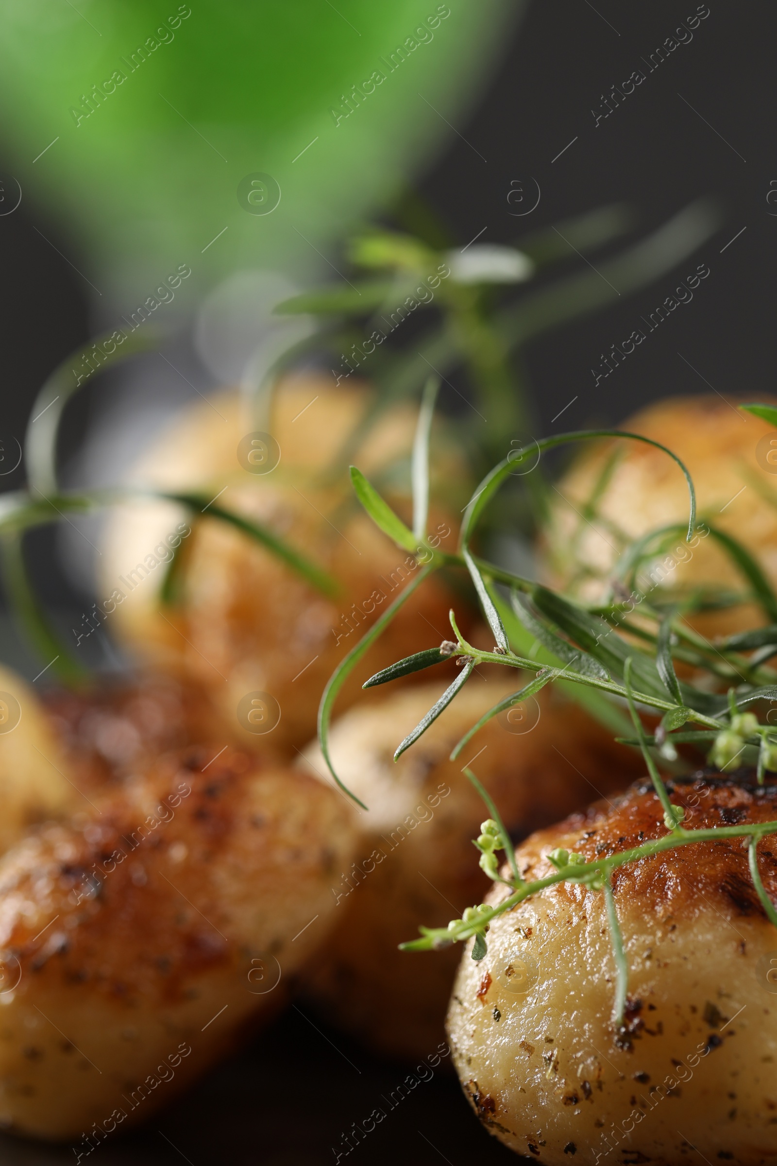 Photo of Delicious grilled potatoes with tarragon on table, closeup