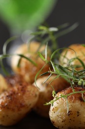 Photo of Delicious grilled potatoes with tarragon on table, closeup