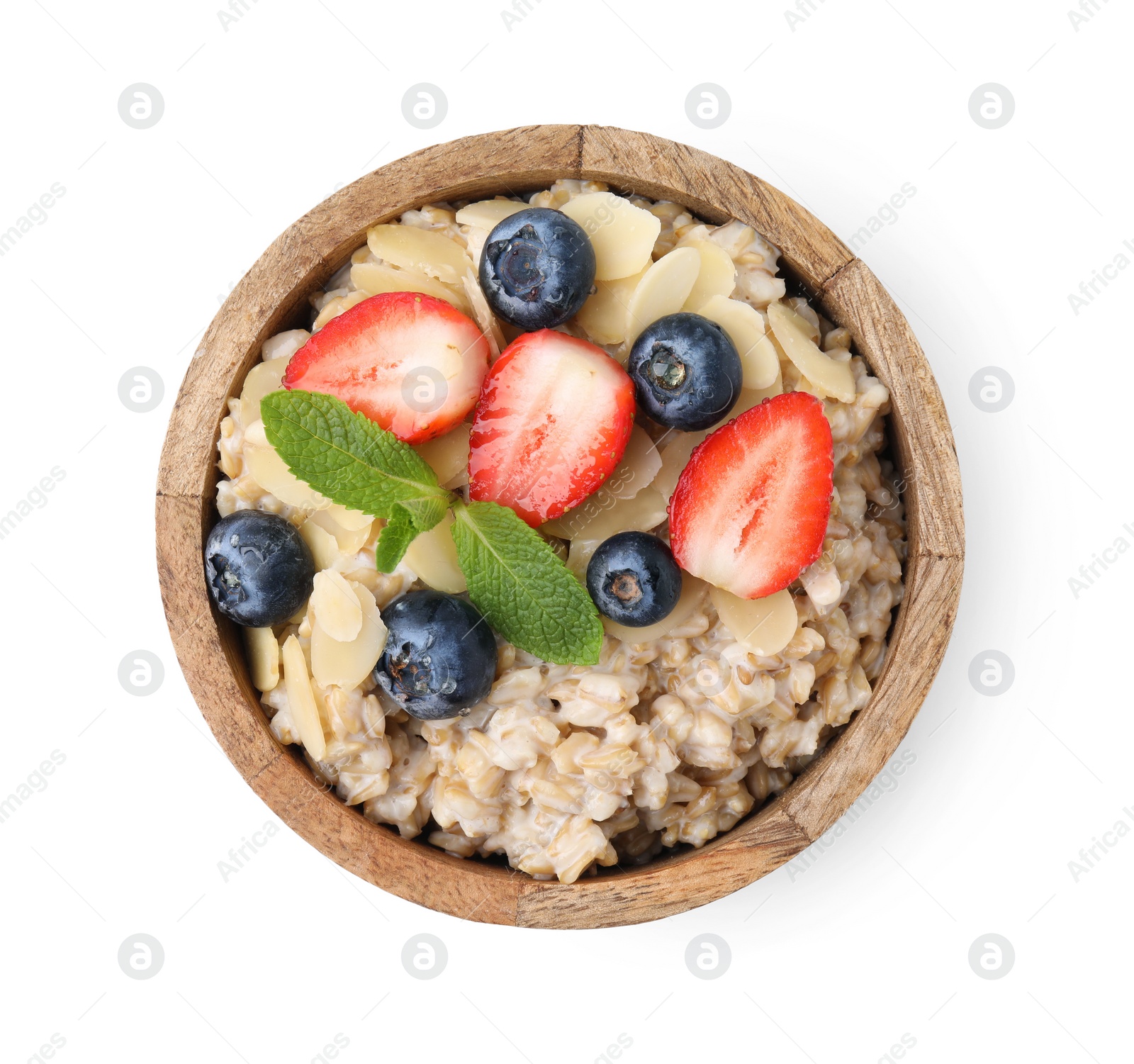 Photo of Tasty oatmeal with strawberries, blueberries and almond flakes in bowl isolated on white, top view