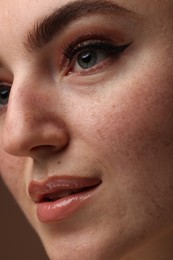 Photo of Beautiful woman with makeup and fake freckles, closeup