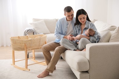 Happy family with cute baby on sofa at home