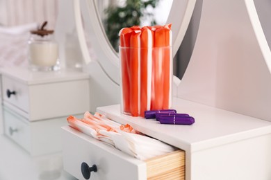 Photo of Dressing table with different feminine hygiene products indoors