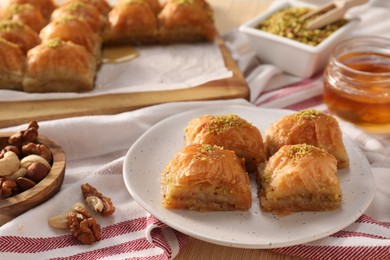Photo of Delicious sweet baklava with nuts and honey on table