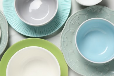 Photo of Beautiful ceramic dishware on white table, flat lay