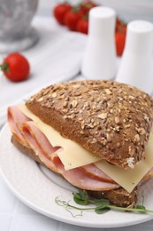 Delicious sandwich with ham and cheese on table, closeup