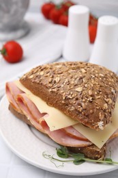 Photo of Delicious sandwich with ham and cheese on table, closeup