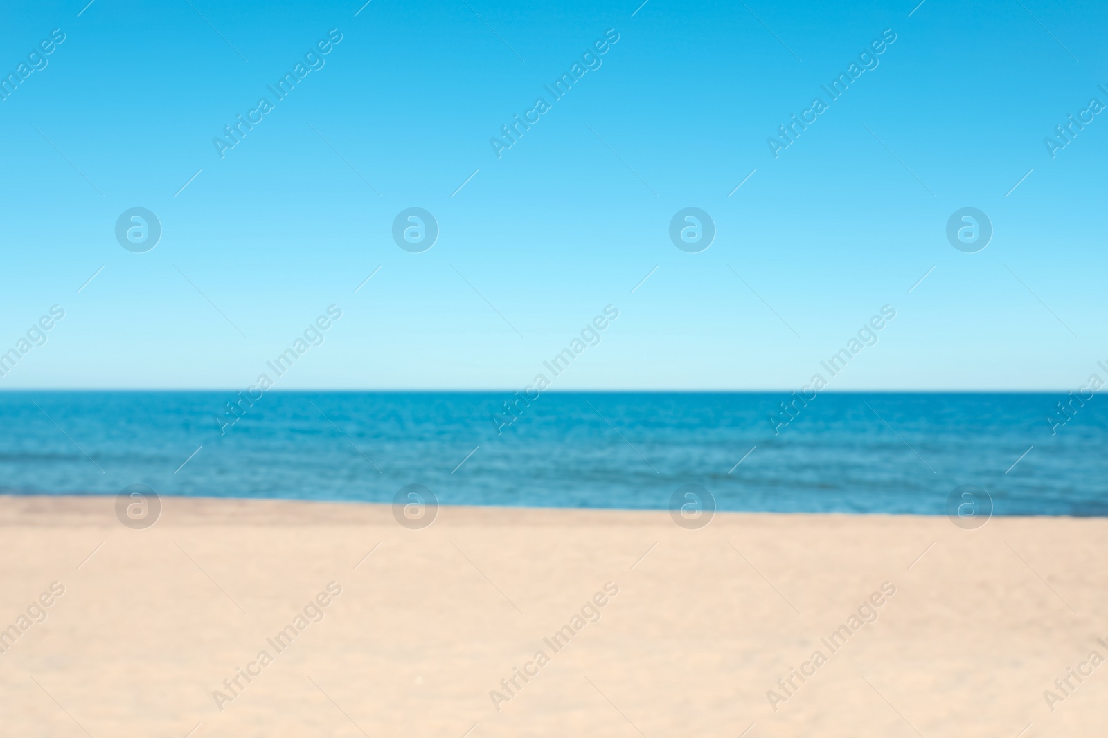 Photo of Blurred view of sandy beach near sea