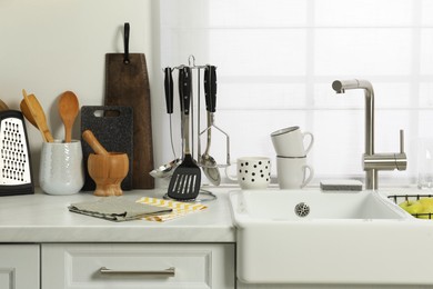 Photo of Countertop with sink and cooking utensils in kitchen