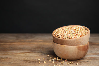 Photo of Green buckwheat on wooden table. Space for text