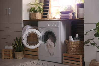 Photo of Stylish room interior with washing machine. Design idea