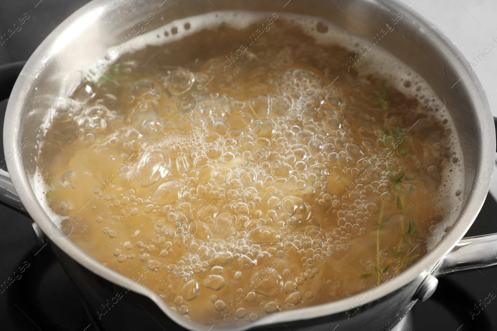 Photo of Cooking pasta in pot on stove, closeup view