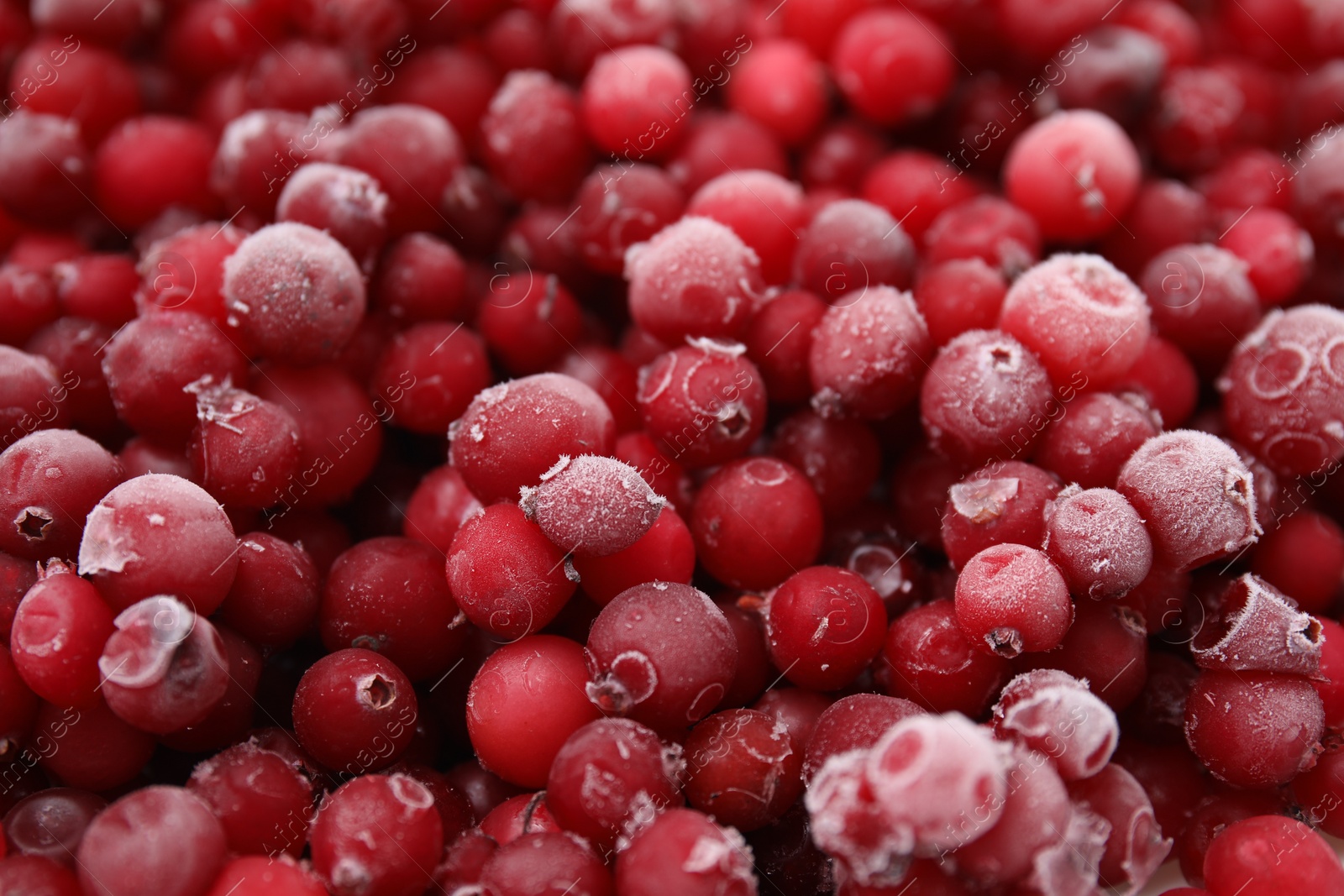 Photo of Frozen red cranberries as background, closeup view