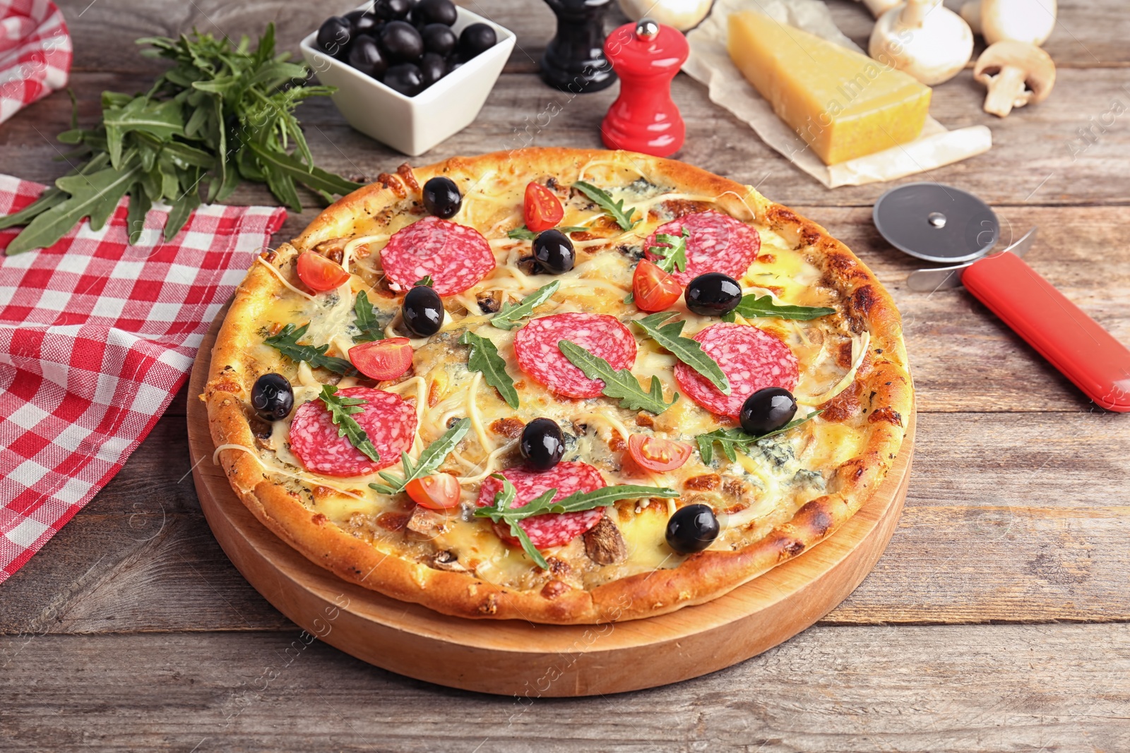 Photo of Delicious pizza with tomatoes and sausage on table