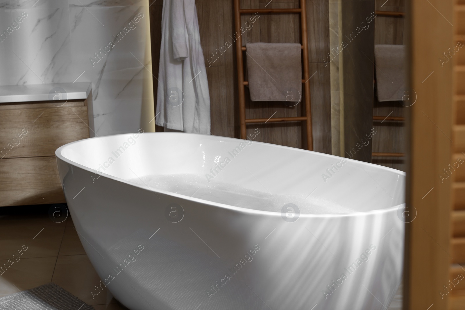 Photo of Stylish bathroom interior with white tub. Idea for design