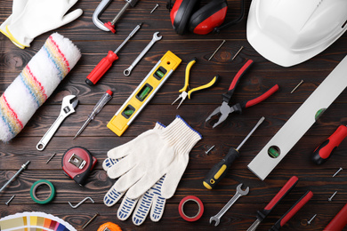 Photo of Flat lay composition with different construction tools on wooden background