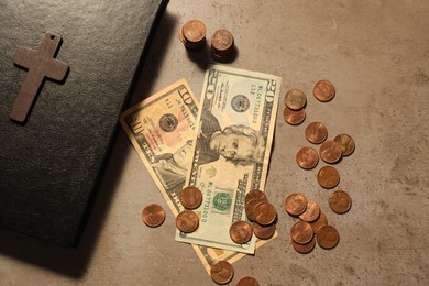 Photo of Donate and give concept. Coins, Bible, cross and dollar banknotes on grey table, flat lay