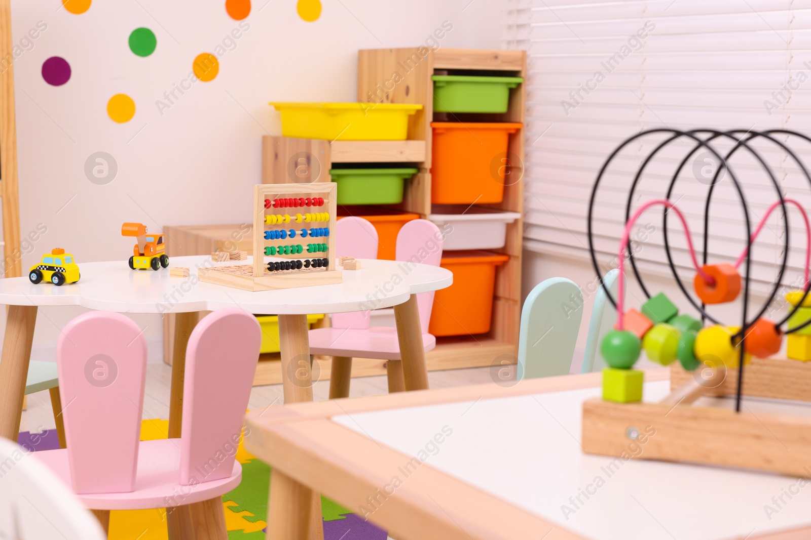 Photo of Stylish kindergarten interior with toys and modern furniture