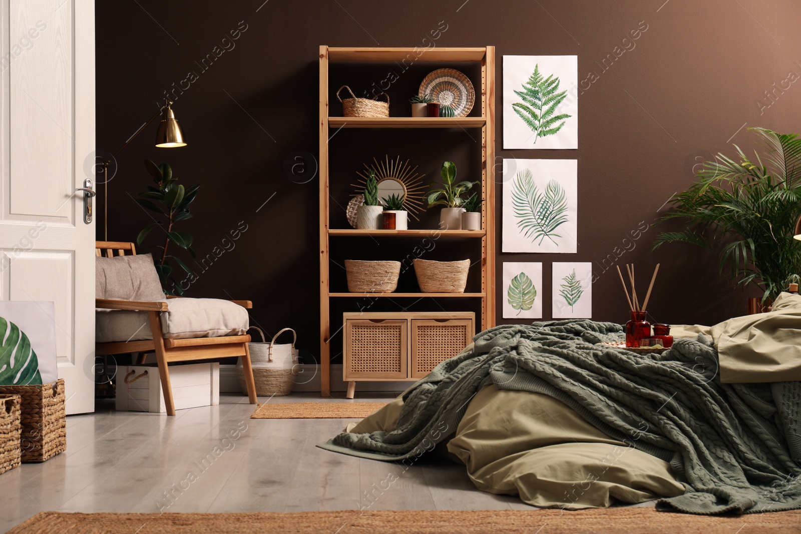 Photo of Stylish interior with large comfortable bed and potted plants