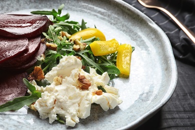 Plate with delicious beet salad on table, closeup