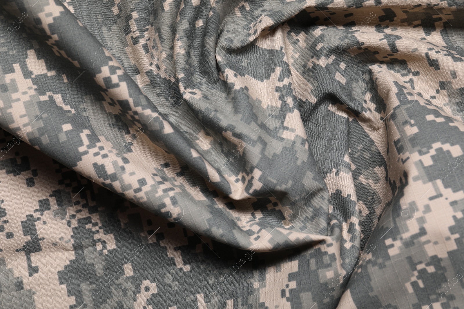 Photo of Texture of crumpled camouflage fabric as background, top view