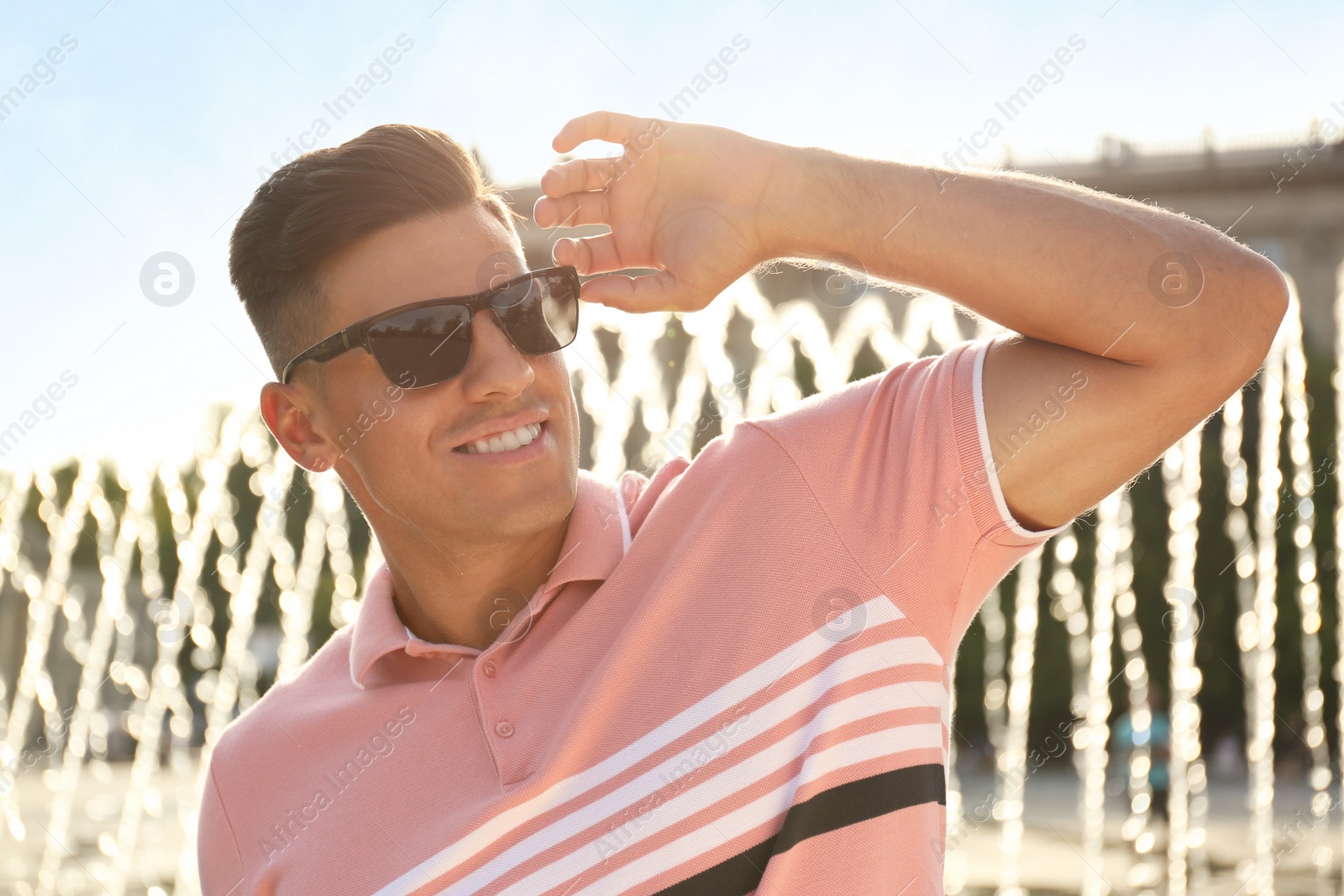 Photo of Handsome man wearing stylish sunglasses on city street