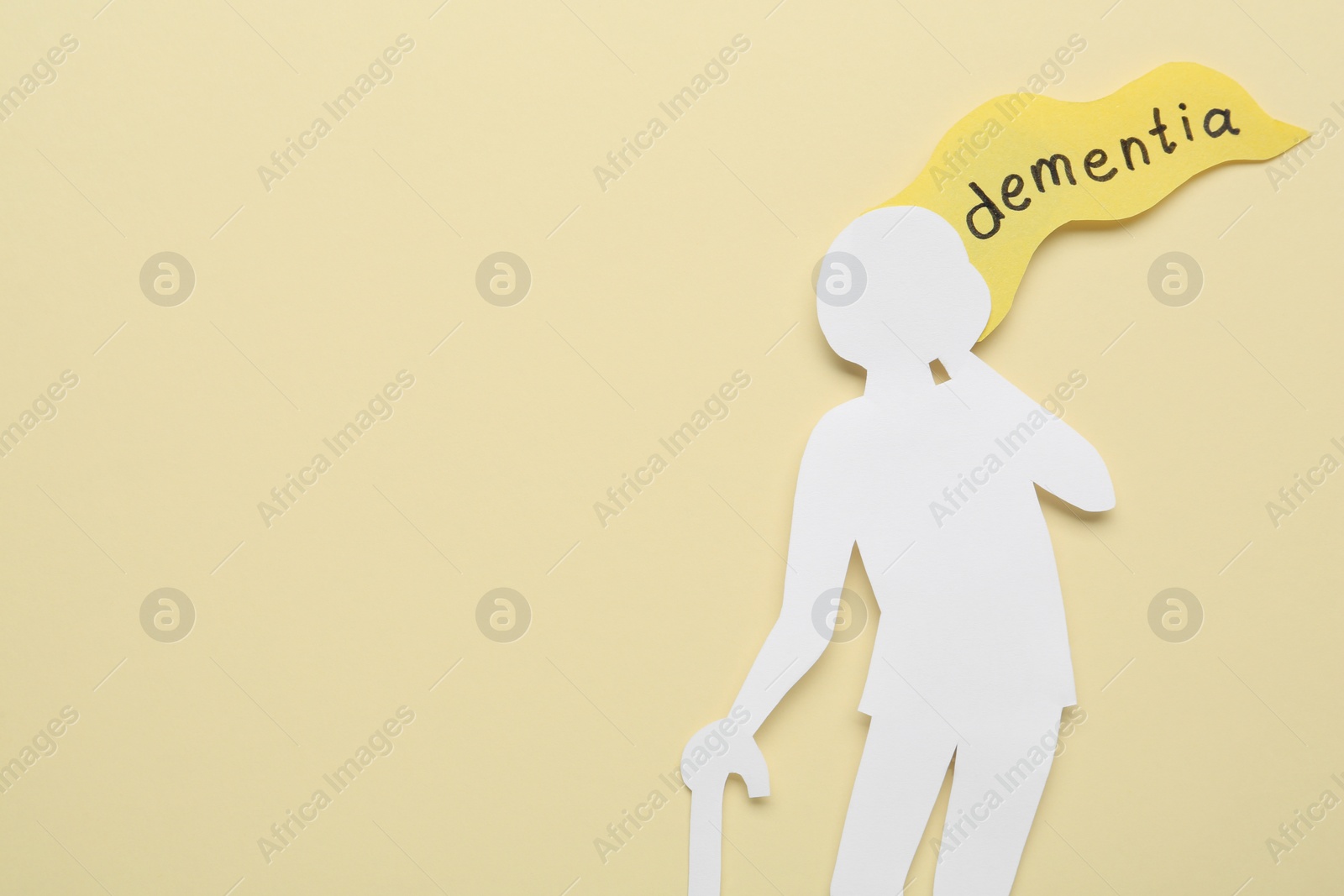 Photo of Old person paper cutout with word Dementia on beige background, top view. Space for text