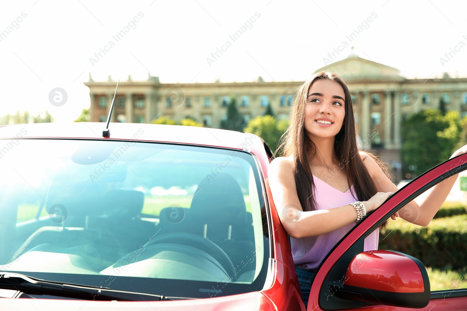 Photo of Young woman near car outdoors on sunny day