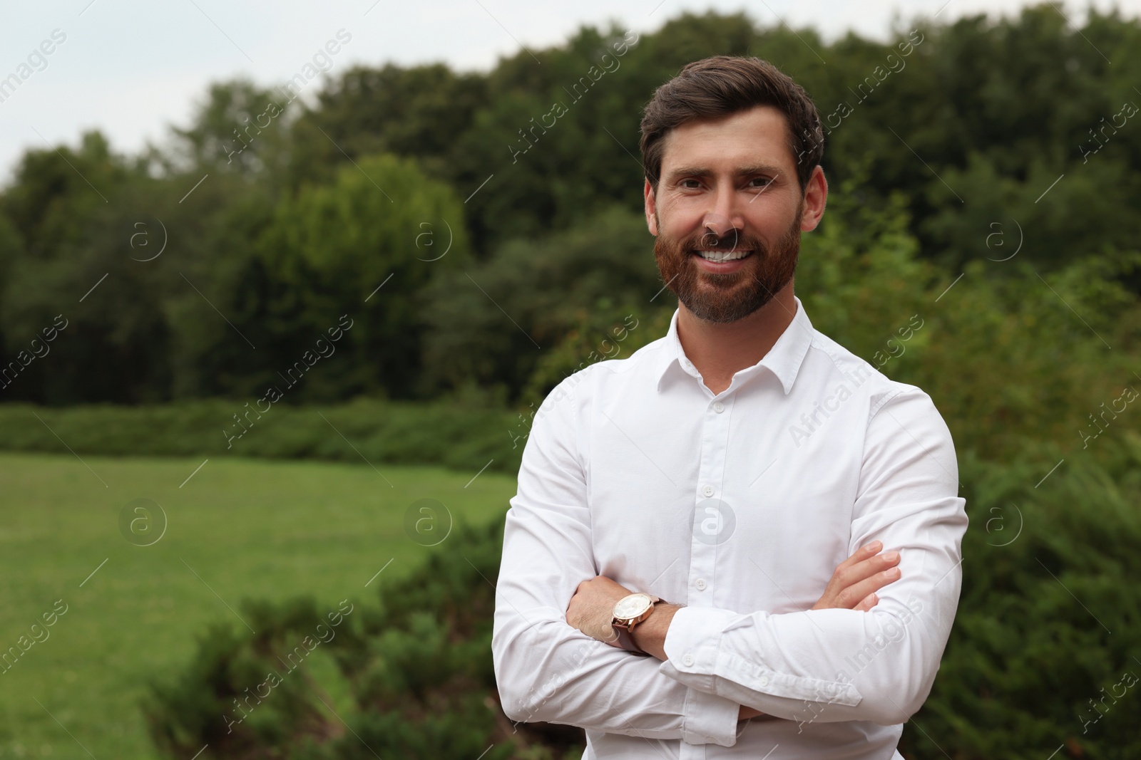 Photo of Portrait of handsome bearded man in park, space for text