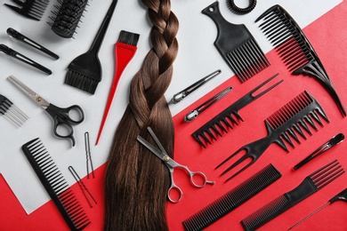 Flat lay composition with hair salon tools on color background