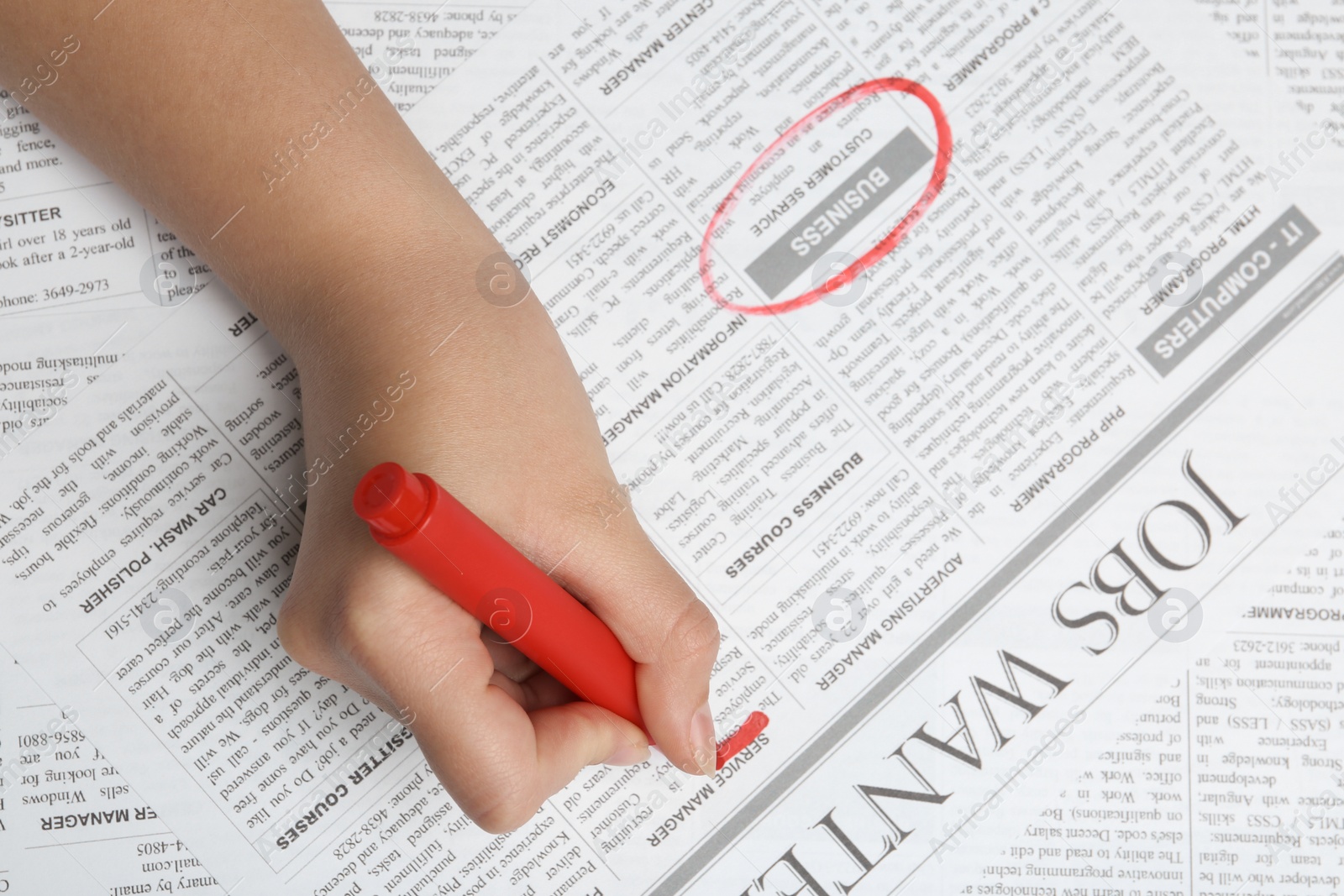 Photo of Woman marking advertisement in newspaper, closeup. Job search concept