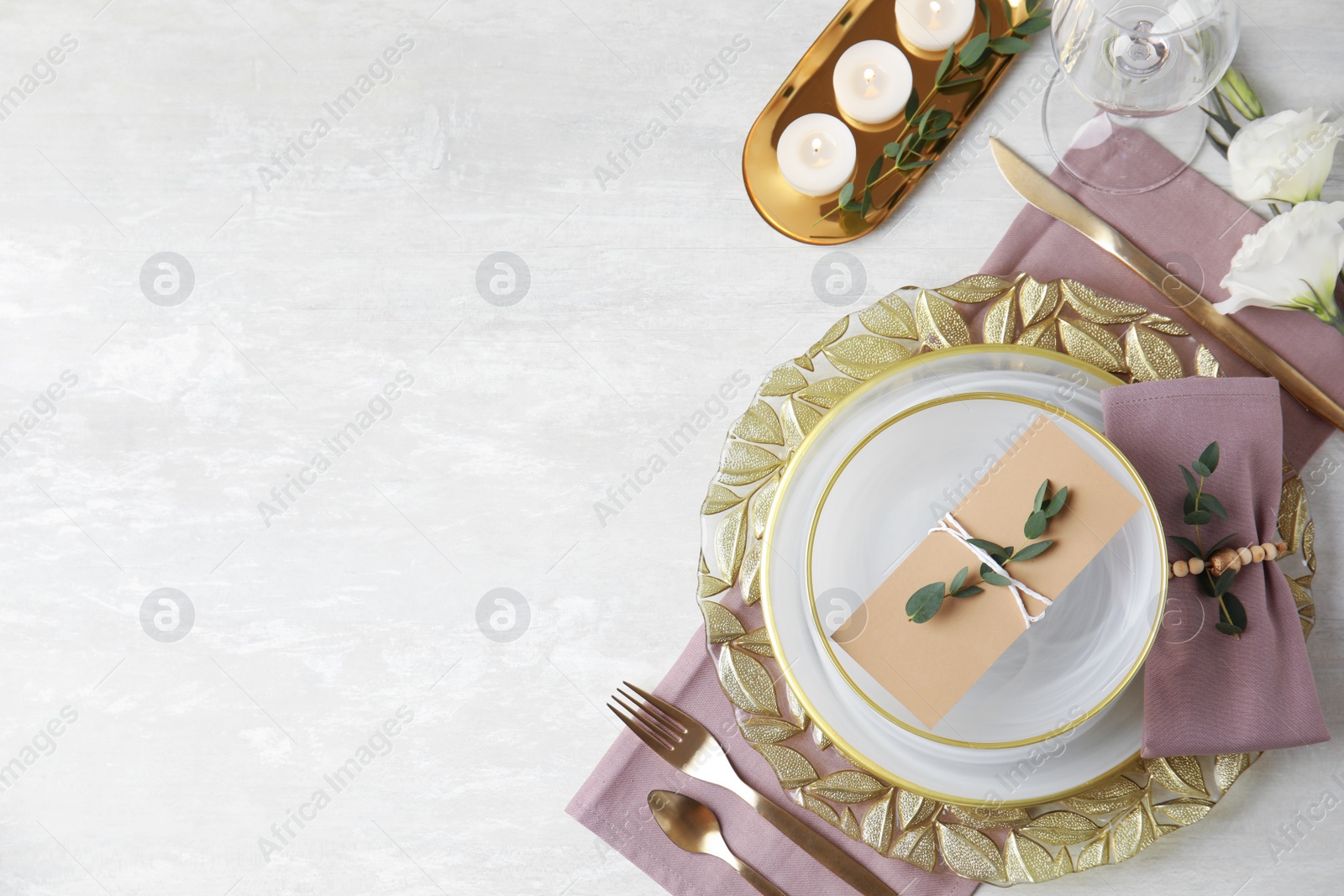 Photo of Elegant festive table setting on light background, flat lay. Space for text