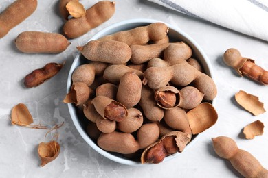 Photo of Delicious ripe tamarinds on light table, flat lay