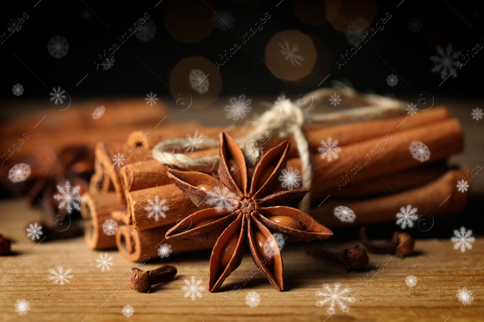 Image of Different spices on wooden table, closeup. Cinnamon, anise, cloves