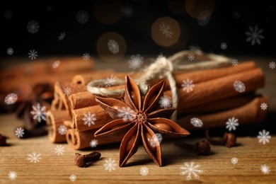 Different spices on wooden table, closeup. Cinnamon, anise, cloves