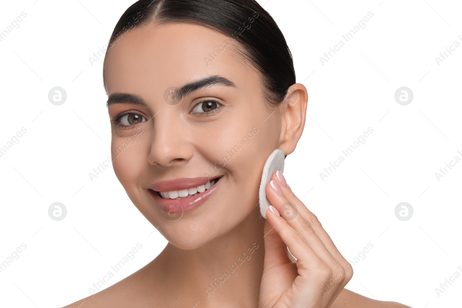 Photo of Beautiful woman removing makeup with cotton pad on white background