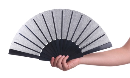 Woman holding black hand fan on white background, closeup