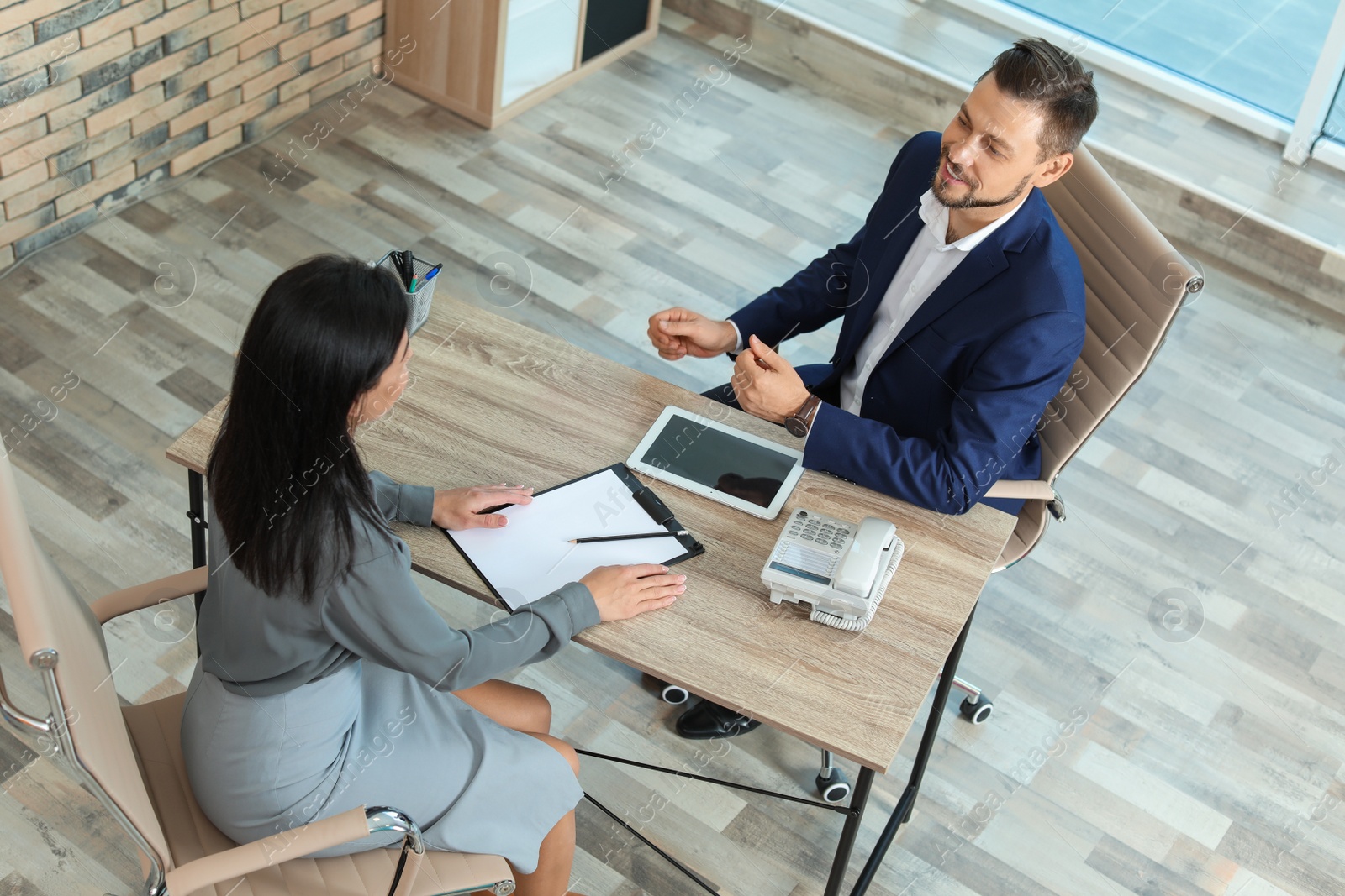 Photo of Human resources manager conducting job interview with applicant in office