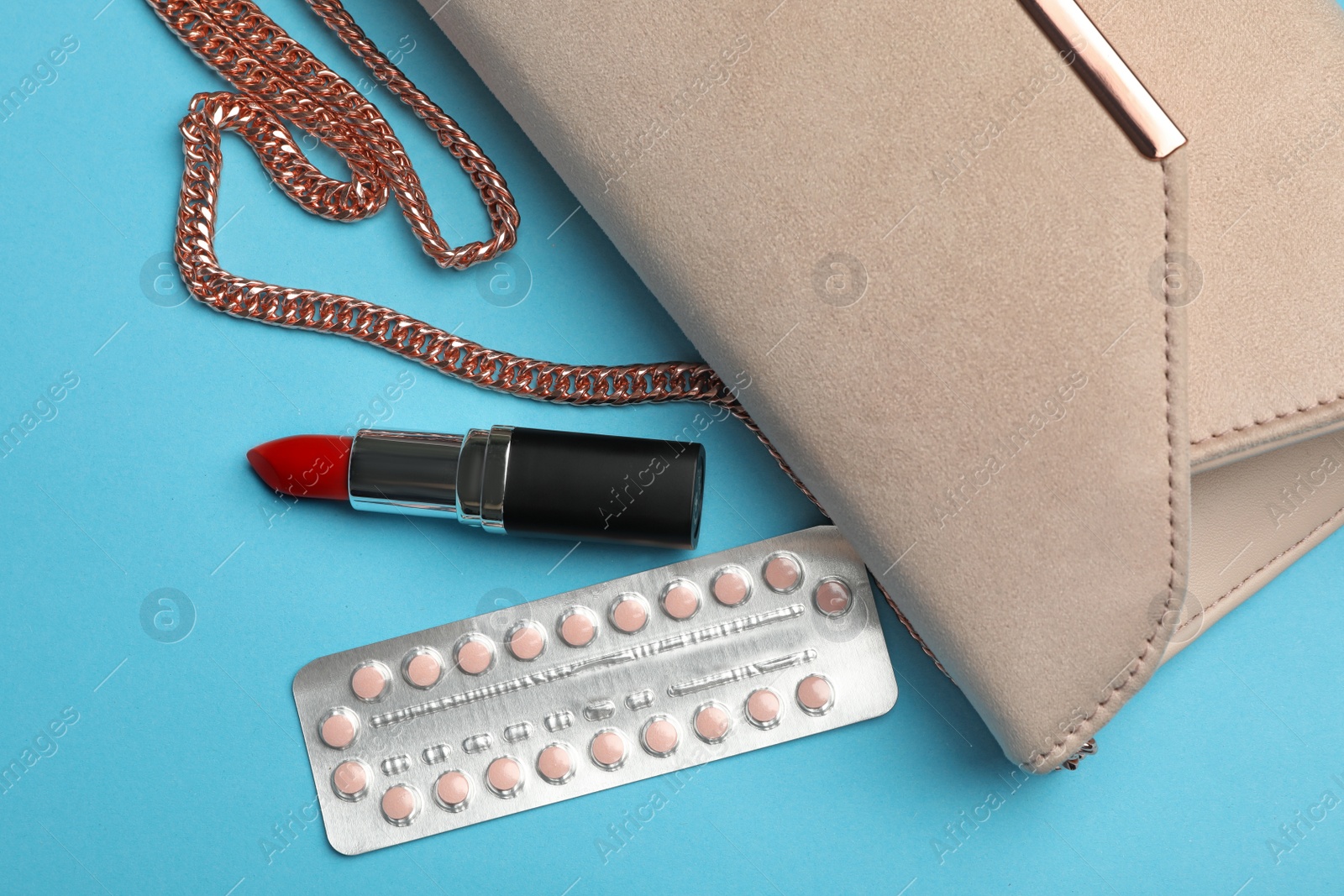 Photo of Flat lay composition with birth control pills on light blue background. Safe sex concept