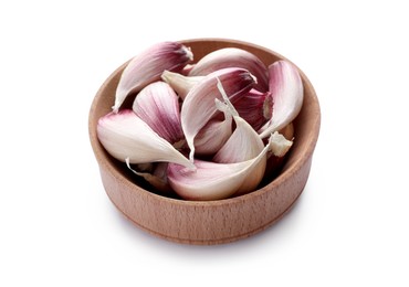 Photo of Unpeeled garlic cloves in wooden bowl isolated on white