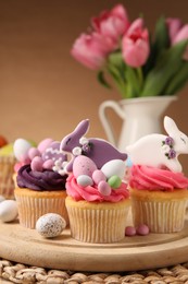 Tasty cupcakes with Easter decor on table