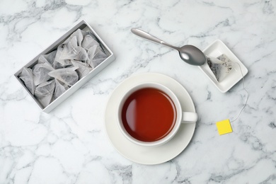 Photo of Flat lay composition with delicious hot tea on marble background