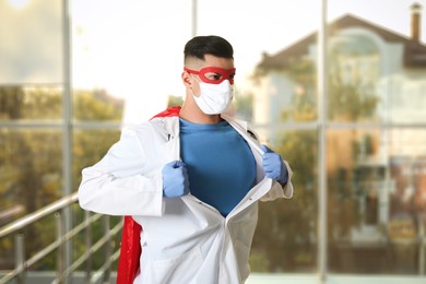 Photo of Doctor wearing face mask indoors. Super hero power for medicine