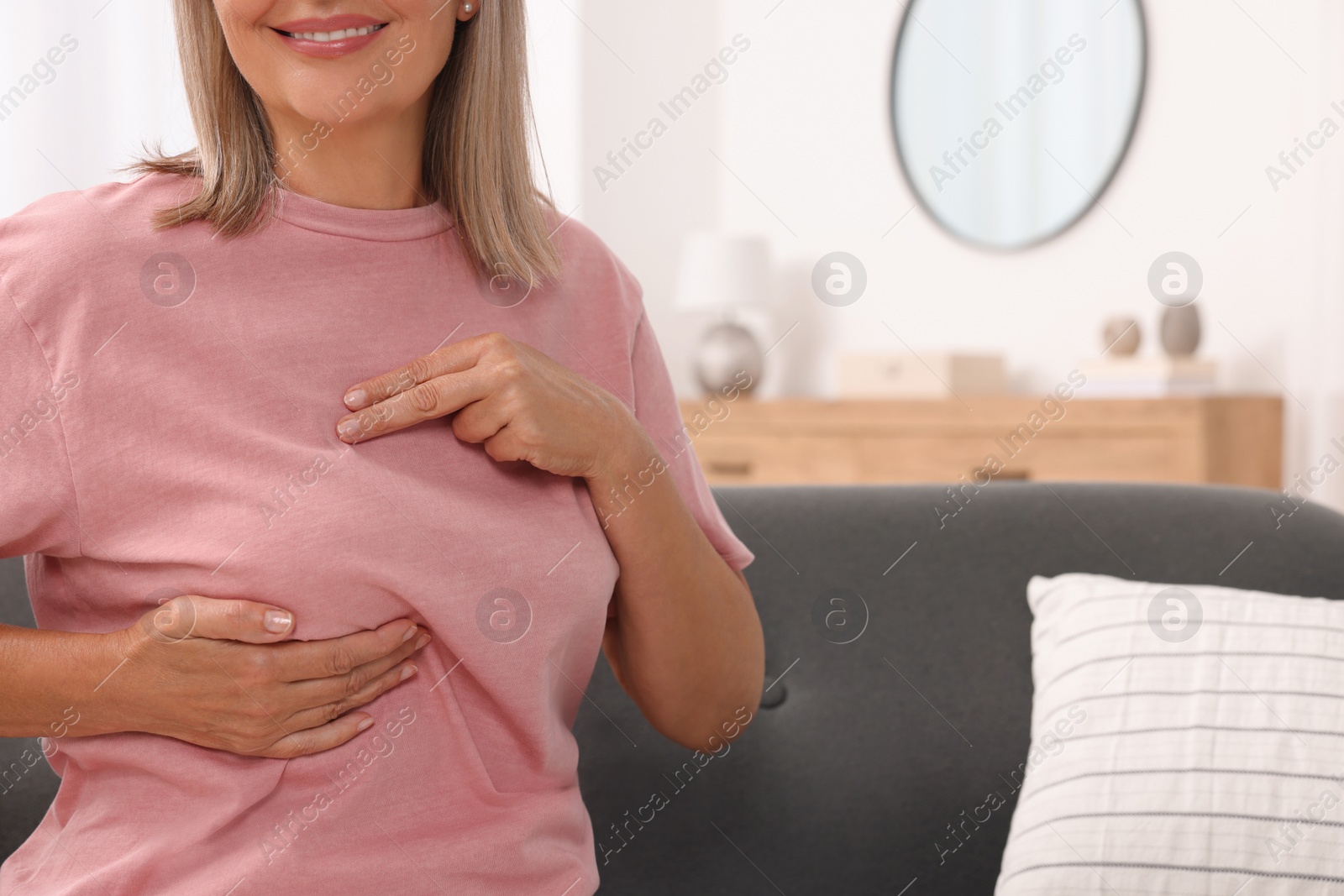 Photo of Woman doing breast self-examination at home, closeup. Space for text